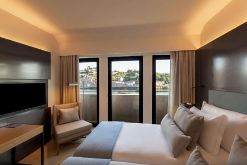 a hotel room with a bed and a television at NEYA Porto Hotel in Porto