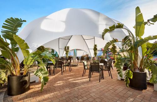 a marquee with tables and chairs under a white tent at Hotel Maria in Dębno Polskie