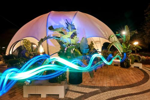 a display of blue and green lights in front of a building at Hotel Maria in Dębno Polskie