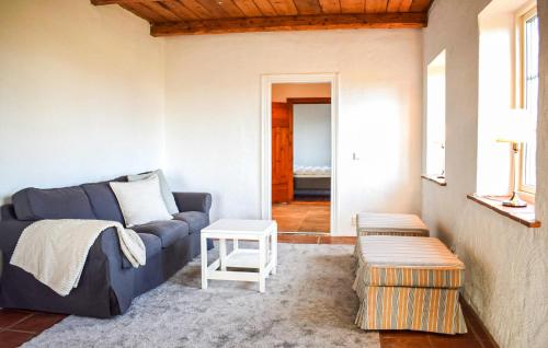 a living room with a blue couch and a table at Lovely Home In Skivarp With Wifi in Skivarp