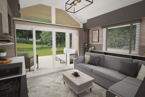 a living room with a couch and a table at Sandaway Holiday Park in Combe Martin
