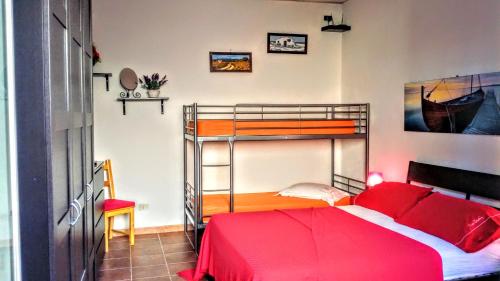 a bedroom with a bunk bed with a red bedspread at Casa Filomena in Ischia