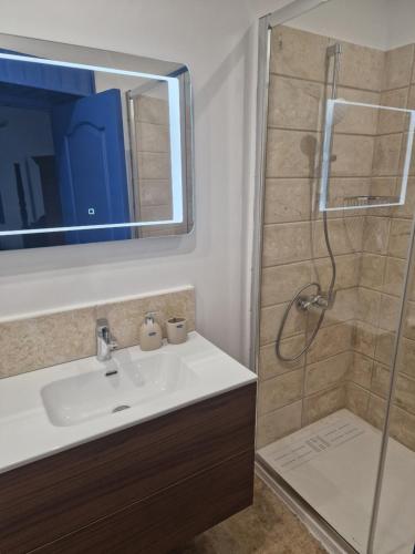 a bathroom with a sink and a shower at The Courtyard Suite in Limassol