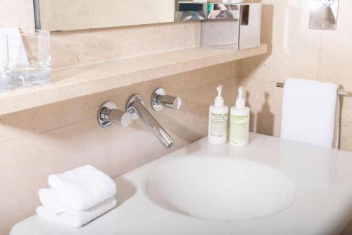 a bathroom with a sink with towels on it at St Martins Lane London in London