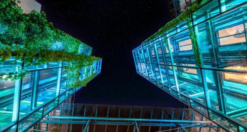 two tall buildings at night with the sky at PLAZA INN Stuttgart-Ditzingen in Ditzingen