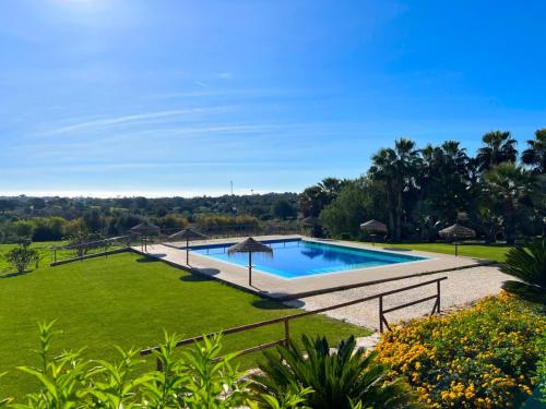 an image of a swimming pool in a garden at Quinta Saleiro Guesthouse in Olhão