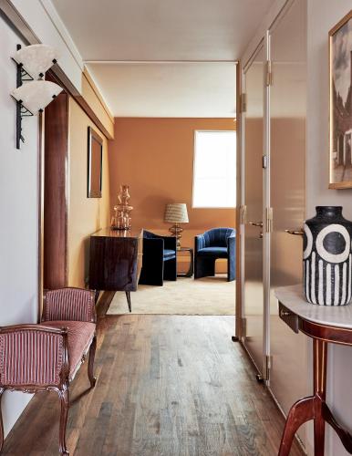 a living room with a couch and a chair at De L’Europe Amsterdam – The Leading Hotels of the World in Amsterdam