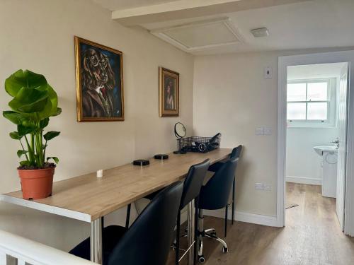 a dining room with a wooden table and chairs at Spacious 4-Bed Apartment In City Centre in Brighton & Hove
