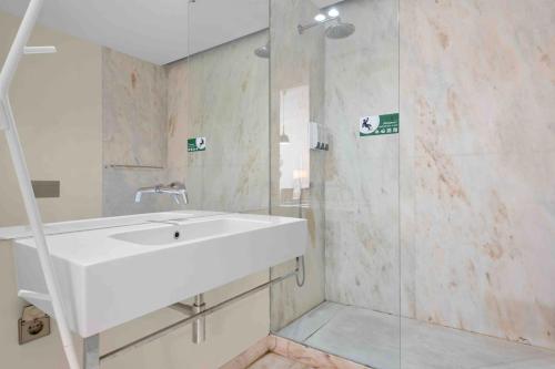 a bathroom with a white sink and a shower at The João I Collection Two Bedroom in Lisbon
