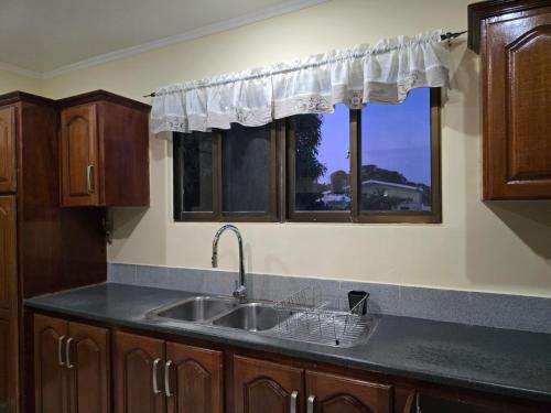 a kitchen with a sink and two windows at Apartment in The Park in Providence