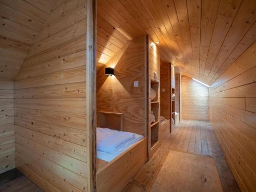 a wooden sauna with a bed in the middle at Holiday home in Petten with garden in Petten