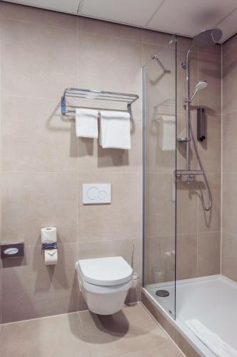 a bathroom with a toilet and a shower at PLAZA Premium Den Haag City Center in The Hague