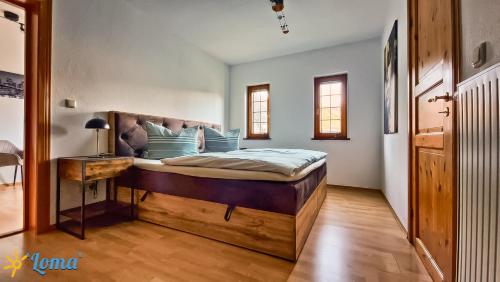 a bedroom with a large bed with blue pillows at Ferienwohnung 'Loma', im schönen Veischedetal ! in Olpe