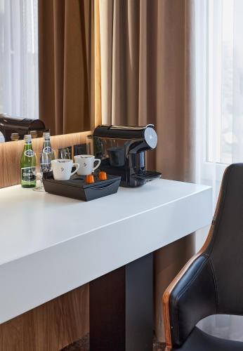 a table with a coffee maker and two cups on it at Hotel Maria in Dębno Polskie