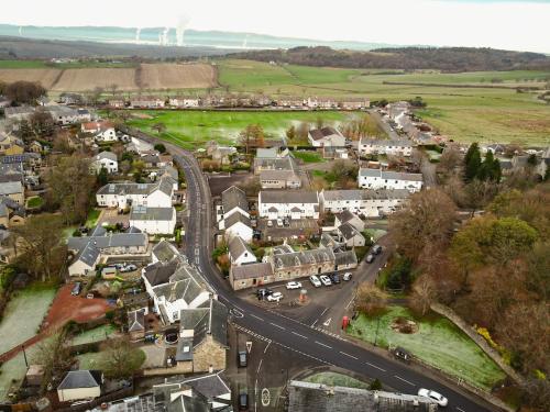 an aerial view of a small town with a road at The Post Office in Torphichen