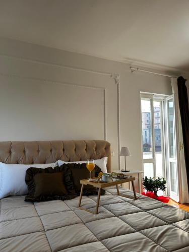 a bedroom with a large bed with a table at B&B MareLuna in Angri