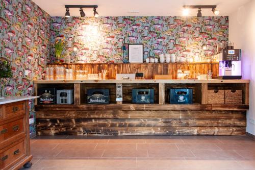 a store with a wall with colorful wallpaper at Forellenhof Wald- und Wiesenquartier in Bad Berleburg