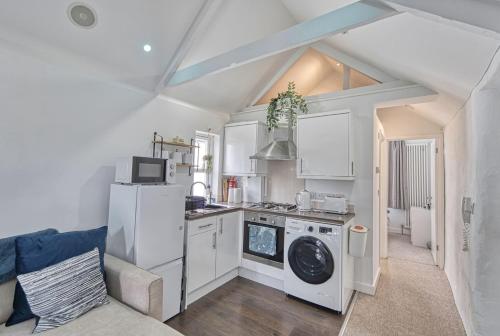 a kitchen with a washer and dryer in a room at Host & Stay - Sail Loft in Hayle