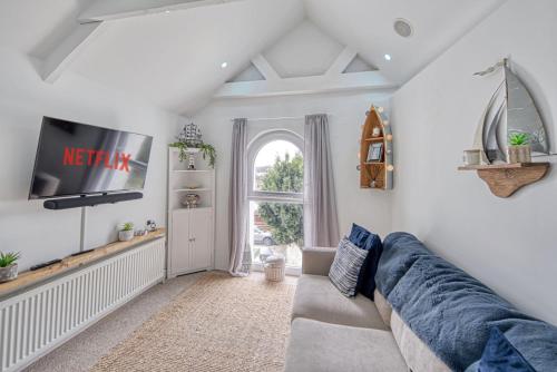 a living room with a couch and a tv at Host & Stay - Sail Loft in Hayle