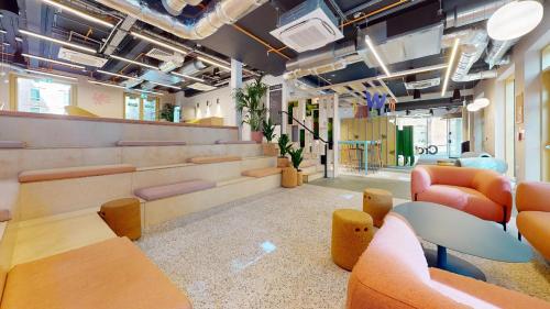 a room with orange chairs and a table and chairs at For Students Only iQ Signal Place Nottingham in Nottingham