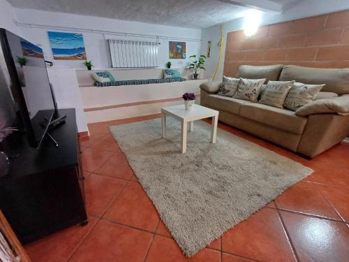 a living room with a couch and a table at Apartamento entero en la montaña in El Pont de Vilomara