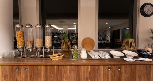 a wooden counter with bowls and other items on it at PLAZA Premium Almere in Almere