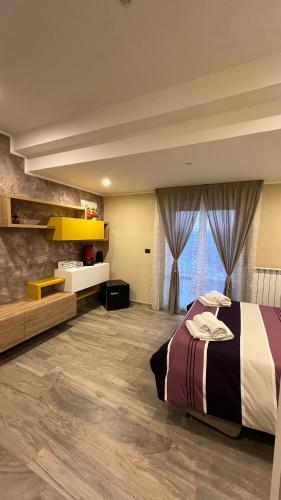 a bedroom with a bed and a large window at Belvedere Vallata Affitti brevi in Vallata