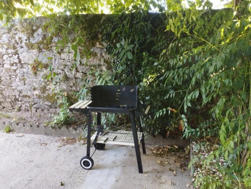a picnic table with a laptop on it next to a wall at Maison avec jardin in Saint-Amand-sur-Sèvre