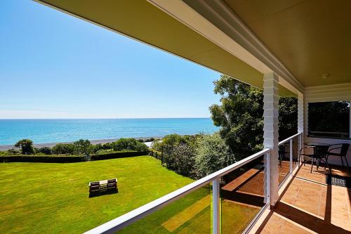 a balcony of a house with a view of the ocean at Bendamere House Bed & Breakfast in Kaikoura