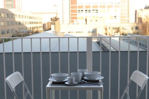 a table with cups and saucers on a balcony at Gonin 58 in Milan