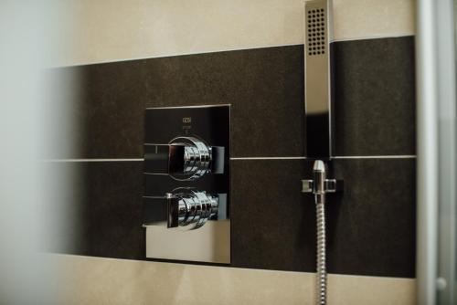 a mirror in a bathroom with a shower at Hotel Schmachtendorf in Oberhausen