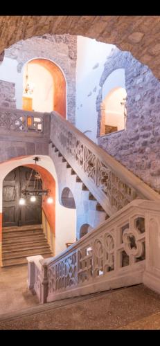 a stairway in a building with a stone wall at Schloss Freudenstein in Appiano sulla Strada del Vino