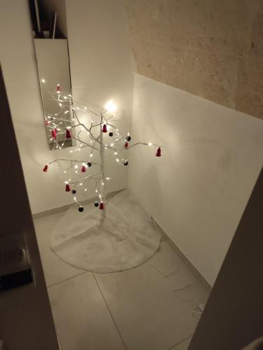 a white room with a christmas tree with lights at La Casaredda Guesthouse, 69-71 in Grottaglie