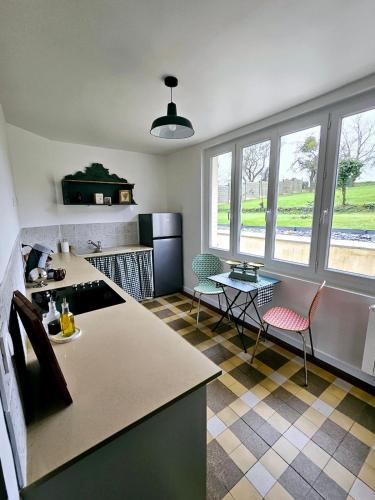 a kitchen with a table and chairs in a room at Le Clos Bernadette in Boissy-le-Bois