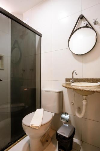 a bathroom with a toilet and a sink at Marezzi Hotel Aracaju in Aracaju