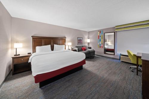 a hotel room with a large bed and a desk at Hampton Inn Franklin in Franklin