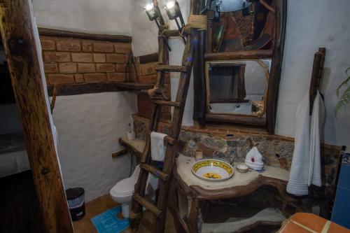 a bathroom with a sink and a mirror at La Cabaña del Abuelo in Lourdes