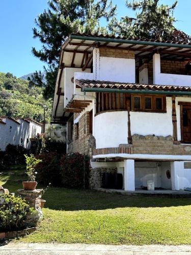 a large white building with a yard and trees at La Cabaña del Abuelo in Lourdes