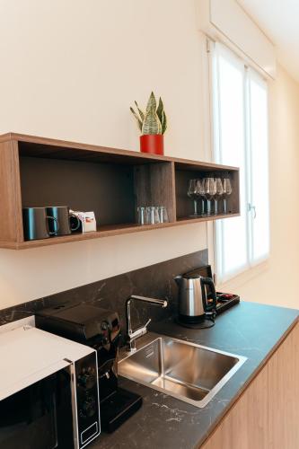 a kitchen with a sink and a counter top at Wine & Wellness in Villalta