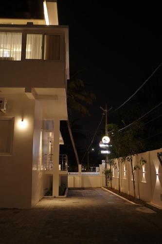a night view of a building with a street at Golden Sands Cherai in Cherai Beach
