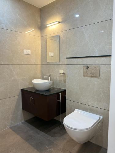 a bathroom with a white toilet and a sink at Golden Sands Cherai in Cherai Beach