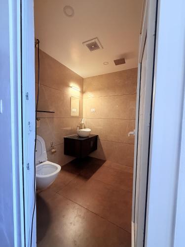 a bathroom with a sink and a toilet in it at Golden Sands Cherai in Cherai Beach