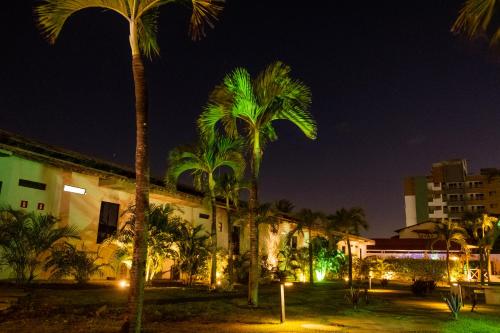 a group of palm trees in front of a building at Marezzi Hotel Aracaju in Aracaju