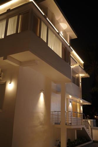 a house with lights on the side of it at night at Golden Sands Cherai in Cherai Beach
