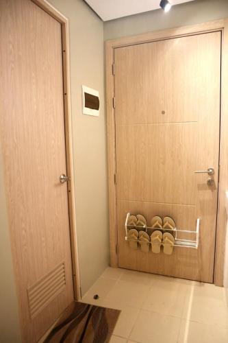 a room with a door with a rack of shoes at Marilao Bulacan VIP flat in Lias