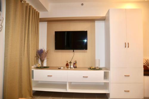 a white cabinet with a television on top of it at Marilao Bulacan VIP flat in Lias