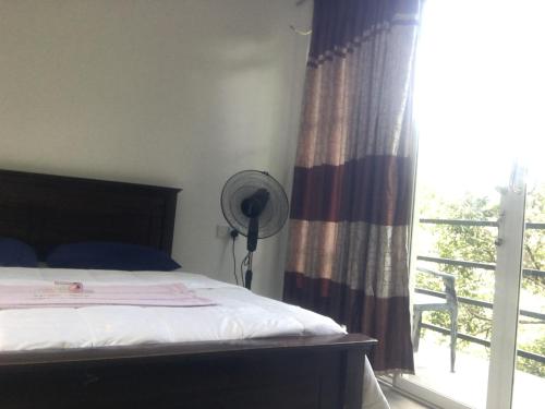 Ένα ή περισσότερα κρεβάτια σε δωμάτιο στο Little wood villa and retreats Doluwa