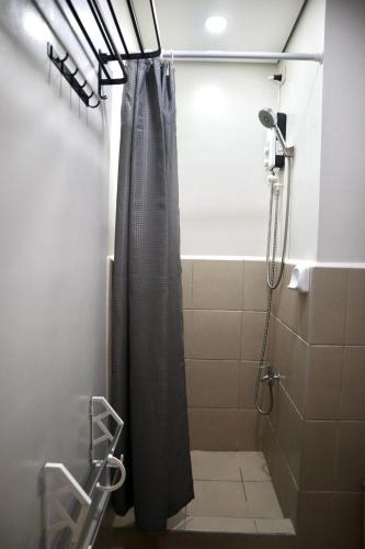 a shower with a shower curtain in a bathroom at Marilao Bulacan VIP flat in Lias