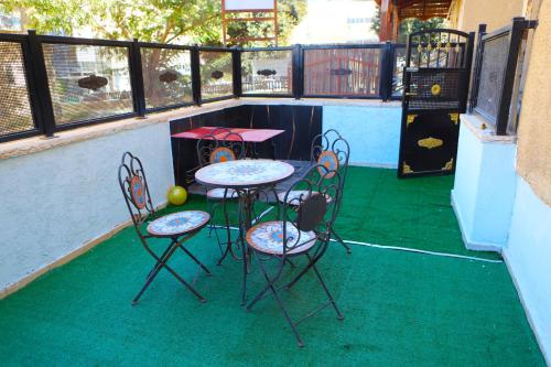 a patio with two chairs and a table with a ball on it at Sweet Home in Dimona