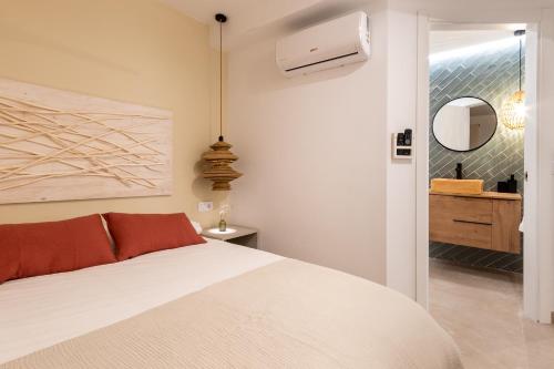a bedroom with a white bed and a mirror at K-DOCK by Nuka Homes in Jávea
